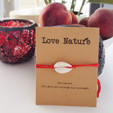 Natural white shell red string bracelet on a gift card